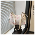 Detail of floral underarm bag with rose prints, bow design, and adjustable strap - Pink Flower