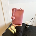 Pink lychee texture mini crossbody bag with a decorative rope knot and thin shoulder strap - Pink