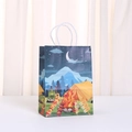 Detail of a paper gift bag featuring a colorful camping illustration with tent and bonfire - Camping Night Theme (481-2)