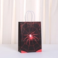 Close-up of Halloween paper gift bag with red spider and web pattern and rope handles - Black Red Spider Pattern (497-4) / 21x15x11cm