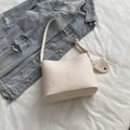 Creamy white lychee pattern bucket bag with adjustable shoulder strap and logo detail - Off White