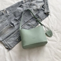 Light green pebble leather bucket bag with adjustable shoulder strap and logo detail - Green