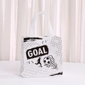 Detail of a white non-woven football gift bag featuring black GOAL text and athlete silhouettes - Grid Silhouette Soccer Style (9040-5)