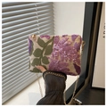 Close-up of beige woven clutch with purple sequin flowers and green leaf embroidery - Purple