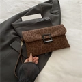 Brown leopard print underarm bag with a black square buckle and slim wrist strap - Brown