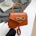 Orange brown crocodile pattern handbag with a sparkling rhinestone bow buckle detail - Brown