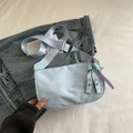 Light blue nylon crossbody bag with adjustable strap and colorful braided charm - With Charm / Blue