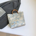 Blue and gold floral jacquard tote bag with natural bamboo handles and structured design - Blue