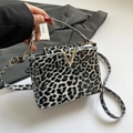 Leopard print women's crossbody bag with glossy finish and golden V-shaped metal buckle - Black