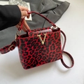 Red leopard print patent leather handbag with gold V buckle and adjustable strap - Red