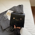 Vintage black structured backpack with gold buckle straps and top handle for women - Black
