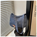Detail of blue denim underarm bag featuring colorful pastel bow prints and wide strap - Dark Blue