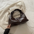 Dark brown glossy patent leather hobo bag with a minimalist crescent shape design - Brown