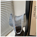 Detail of light blue denim shoulder bag featuring colorful all-over bow embroidery pattern - Light Blue