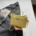 Mini pale yellow PU leather top-handle bag with pebble grain texture and crossbody strap - Yellow