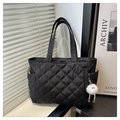 Close-up of black quilted shoulder bag with diamond pattern and plush charm - Black With Pendant