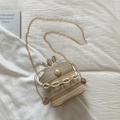 Detail of straw bucket bag with white chunky chain and pearl accent decoration - Beige