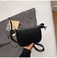 Detail of black pebbled leather mini saddle bag with unique knotted rope shoulder strap - Black