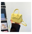 Detail of yellow mini crossbody bag with wavy edge flap and pebble grain texture - Yellow