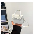 Detail of white lychee pattern PU leather bag with wavy flap and gold hardware - White
