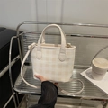 Chic cream checkered tote bag with top handles and slender shoulder strap for daily use - White