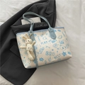 Chic beige tote bag with blue graffiti prints, teddy bear patterns, and a plush bunny charm - With Pendant / Blue