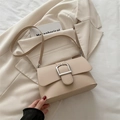 Chic cream leather crossbody bag with oversized silver metal buckle and slim strap - Khaki