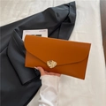 Caramel orange leather envelope clutch with a unique gold metal clasp and sleek finish - Brown