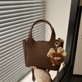 Brown litchi grain leather bucket bag with cute plush charm and crossbody strap - With Pendant / Brown