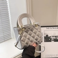 Silver metallic quilted handbag with trapezoidal structure and top handle - With Pendant / Silver