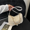 Straw woven underarm bag in creamy white with seashell and pearl charms on gold chain - Beige