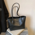 Minimalist black leather tote bag with Fashion tag placed on a silver suitcase - Black without Pendant