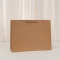 Detail of a brown kraft paper shopping bag with twisted handles on a white surface - Horizontal-XL (40x30x13cm)