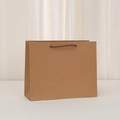 Close-up of premium kraft paper bag with durable brown braided handles and fine texture - Horizontal-Medium (26x21x10cm)