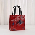 Detail of red non-woven gift bag with spider web patterns and black nylon handles - Red Base Black Spider Style (9029-1)