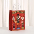 Close-up of Nutcracker soldiers printed on a red Christmas gift bag with rope handles - Style 449-2 (21x15x8cm)