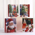 Set of four Christmas paper gift bags with festive illustrations and red rope handles - Assorted Christmas Patterns / Small
