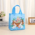 Detailed close-up of a blue Easter non-woven tote bag with cartoon bunny and egg prints - 29*27*12 / Light Blue