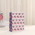 Detail of white paper gift bag with USA flag patterns and twisted rope handles - Stars And Stripes Heart Style (400-2)