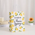Detail of white paper gift bag with yellow lemon prints and woven rope handles - Main Squeeze Artistic Lettering Style (410-6)