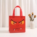 Detail of red Halloween non-woven gift bag with monster face print and sturdy handles - 9014-6
