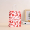 Close-up of white paper gift bag with red hearts and Happy Valentine's Day text - Holiday Wishes Heart Style (369-2)