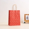 Detail of red Valentine gift bag with white heart pattern and twisted paper handles - Red Heart Wave Style / 21*15*8