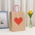 Kraft paper gift bag with a red heart print and twisted rope handle for Valentine's Day - Kraft Paper Large Red Heart Style
