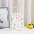 Detail of Happy Easter paper gift bag with cartoon bunny and egg print in festive setting - Happy Easter Chick Style (375-5)