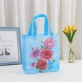Blue non-woven gift bag with vibrant floral print and sturdy handles for Mother's Day - L / Blue