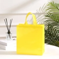 Vibrant yellow non-woven shopping tote bag with handles shown in a fresh lifestyle setting - 29*27*12cm / Yellow
