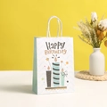 Close-up of birthday paper gift bag with Happy Birthday text and blue candle design - Small / Candle Pattern Light Blue Chevron (605-1)