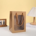 Kraft paper gift bag with large clear window and braided handles on white desk - 20cmx15cmx10cm / Natural Wood Color