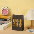 Detail of a black marble texture paper gift bag with yellow leaf prints and white handles - Black Yellow Leaf (902 Black)